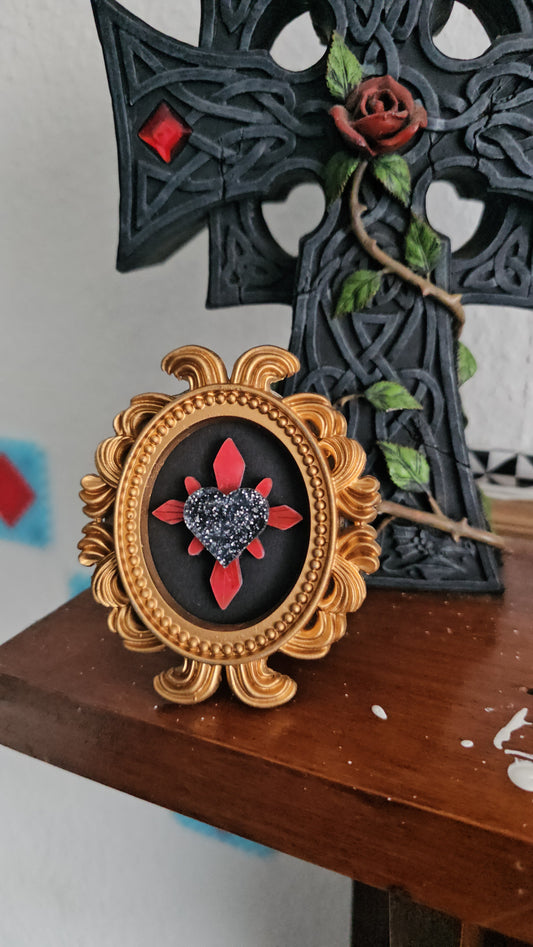 Haunted heart in gold frame